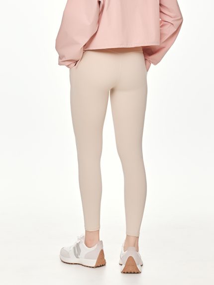 Close-up side-back view of the BEYOURA Estelle Cool Core luxeFIT Leggings in beige