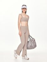 Full front view of the BEYOURA Estelle Flared luxeFIT Leggings in beige styled with a hat and gym bag
