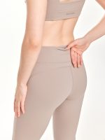 Medium close-up back view of the BEYOURA Estelle Flared luxeFIT Leggings in beige