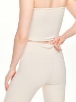 Medium close-up back view of the BEYOURA Estelle Flared luxeFIT Leggings in off-white