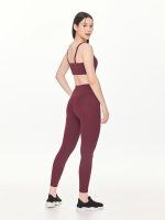 Full side-back view of the BEYOURA Estelle Stretch & Stash luxeFIT Leggings in maroon